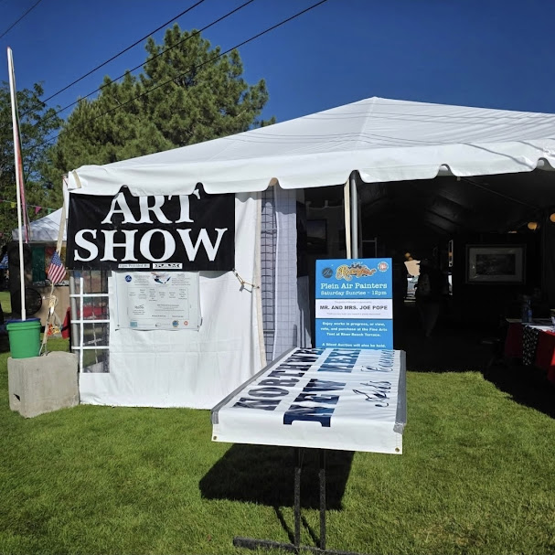Fine art tent at Riverfest featuring artwork from local artists.