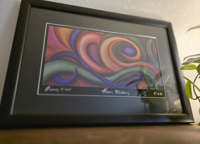 Framed abstract print by artist Karen Ellsbury hanging in a home.