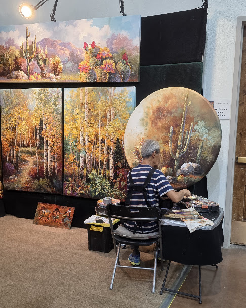 Artist Jamie Lee painting an original Southwestern landscape at his booth during the Ruidoso Art & Wine Festival.