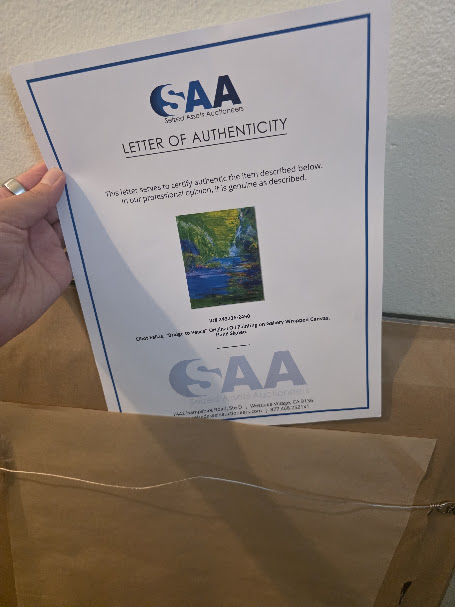 Certificate of authenticity stored on the back of a framed original painting.