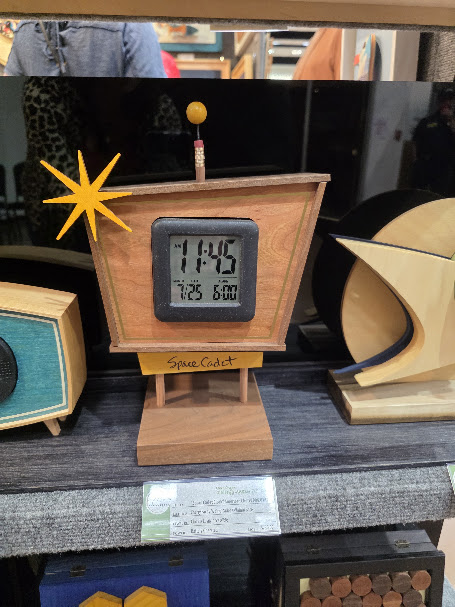 Handmade mid-century modern wooden digital clock displayed by a woodworking artist at the Ruidoso Art Festival.