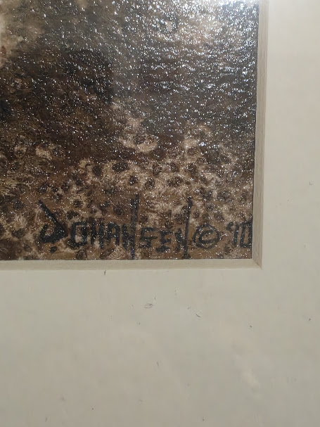 Close-up of an artist's signature on an original mixed media painting.